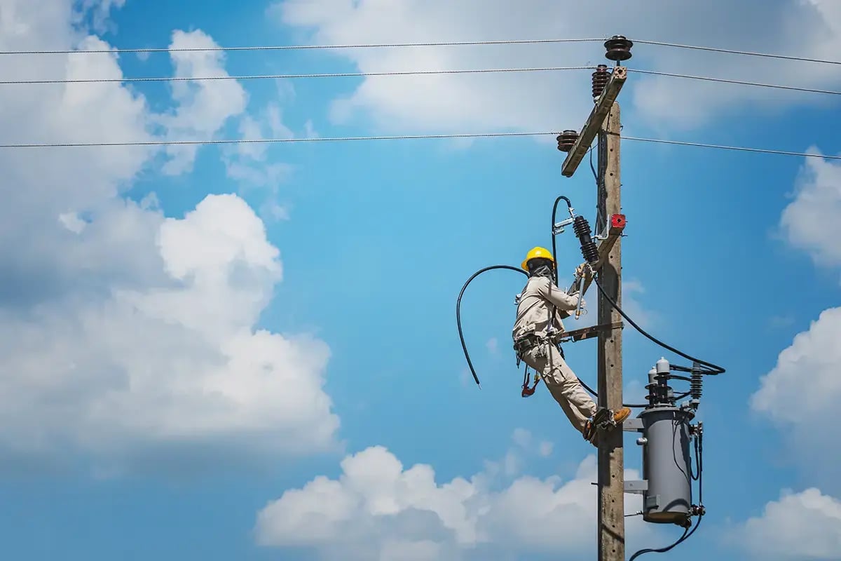 Man working on electrical pole