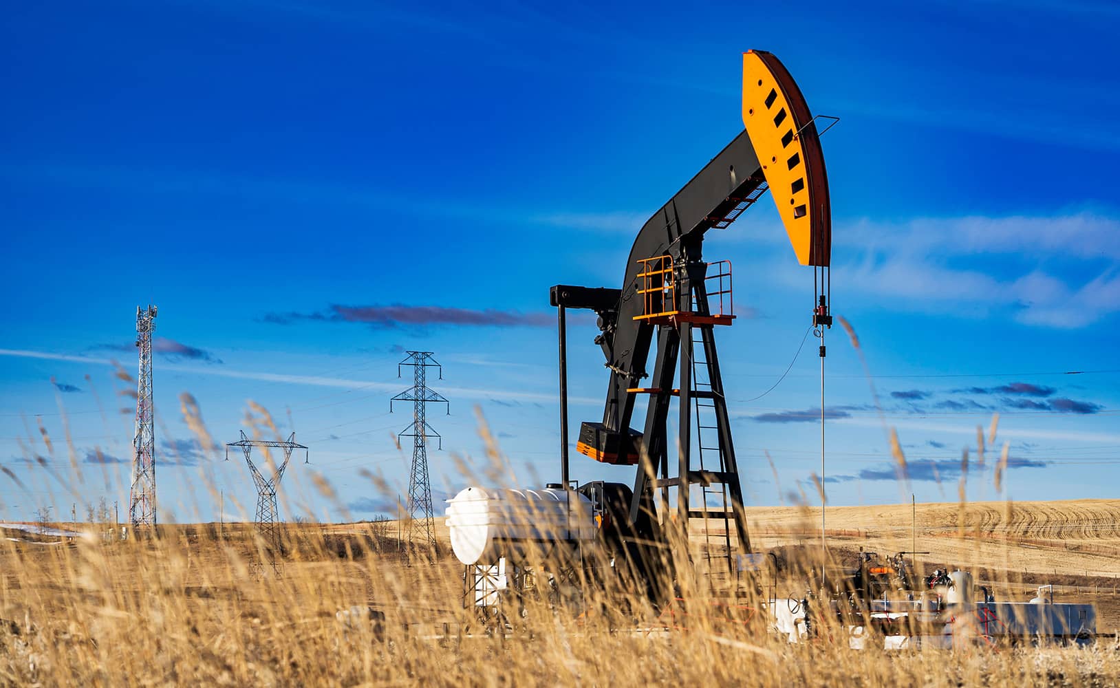 An oil well pumpjack in a farm field