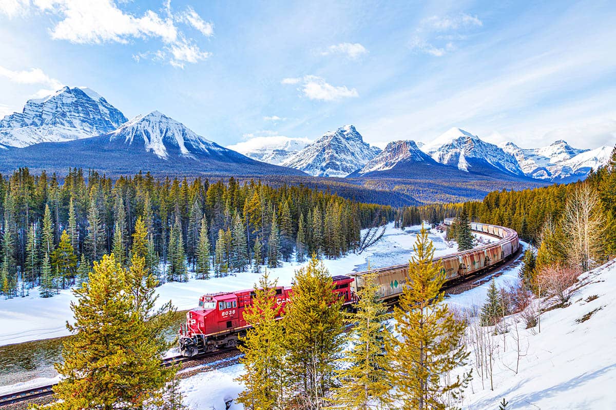 Train passing through Alberta mountains 